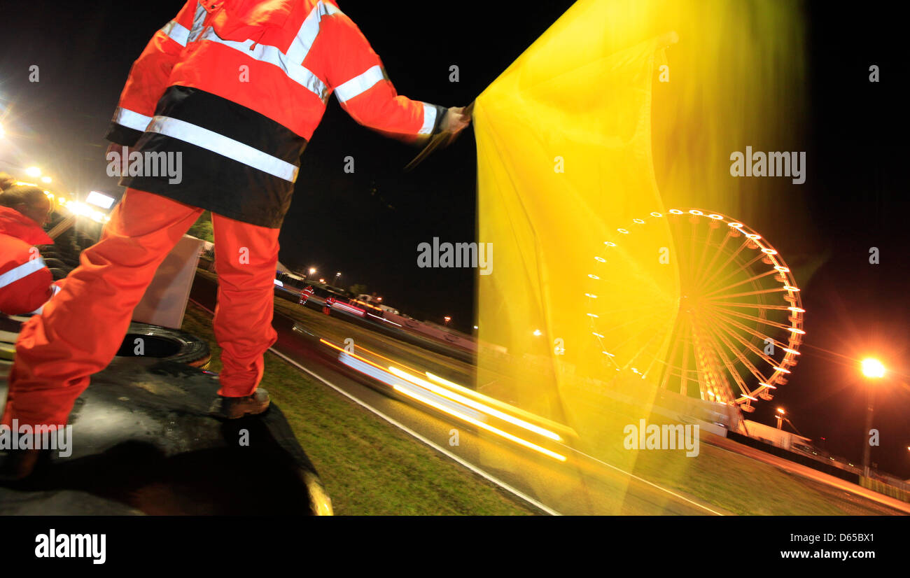 A marshal is waving the yellow flag during the 80th 24 Hours Race of Le Mans on the Circuit de la Sarthe in Le Mans, France 17 June 2012. Photo: Florian Schuh dpa  +++(c) dpa - Bildfunk+++ Stock Photo