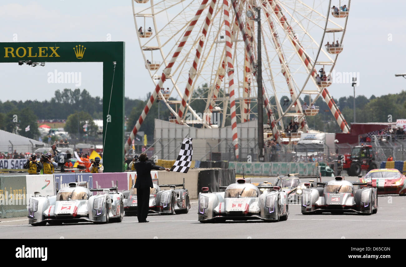 The four Audi race cars are crossing the finish line together at the end of the 80th 24 Hours Race of Le Mans on the Circuit de la Sarthe in Le Mans, France, 17 June 2012. Photo: Florian Schuh dpa  +++(c) dpa - Bildfunk+++ Stock Photo