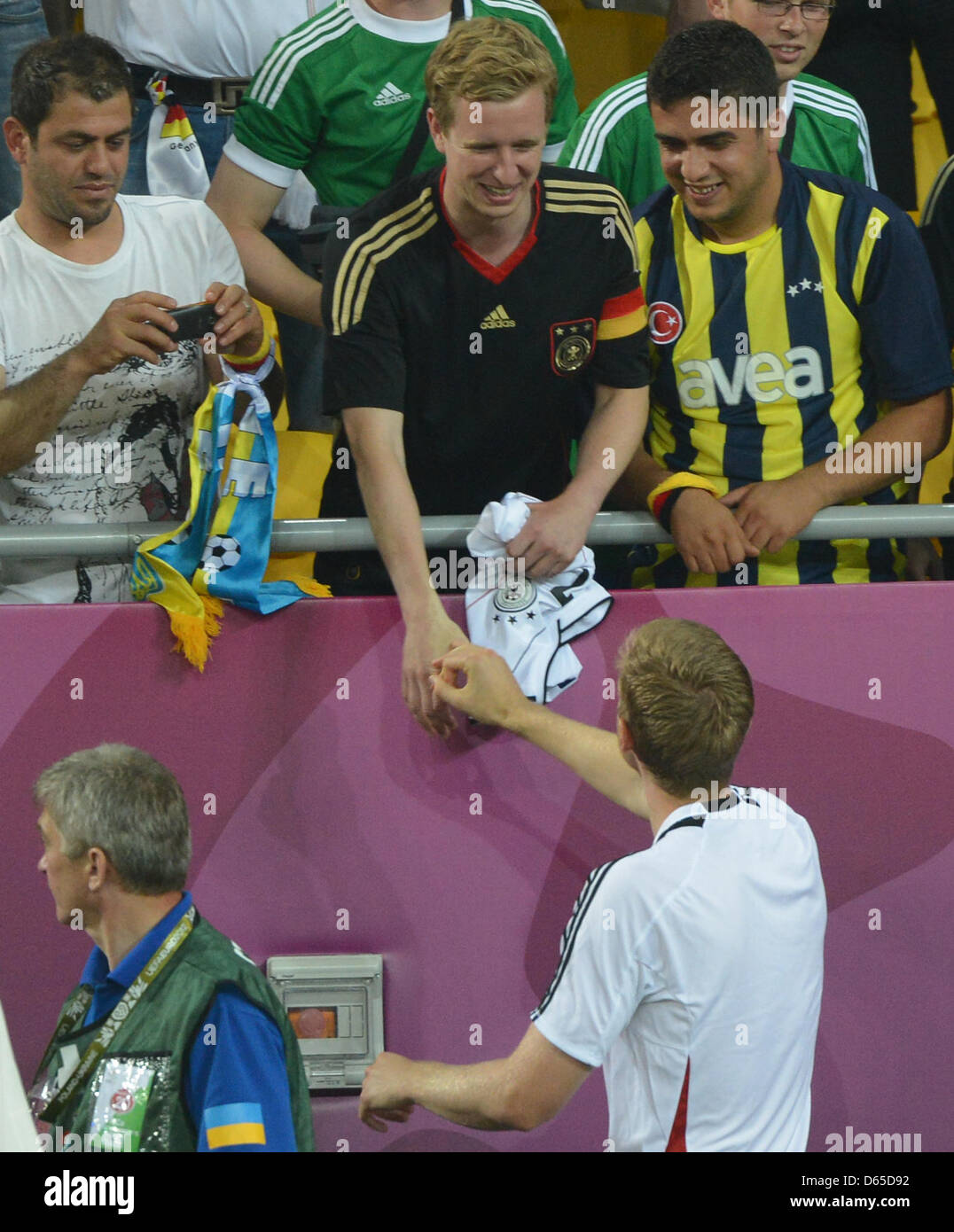 Germany's Per Mertesacker talks to his brother Timo Mertesacker (C) after  during UEFA EURO 2012 group B soccer match Denmark vs Germany at Arena Lviv  in Lviv, the Ukraine, 17 June 2012.