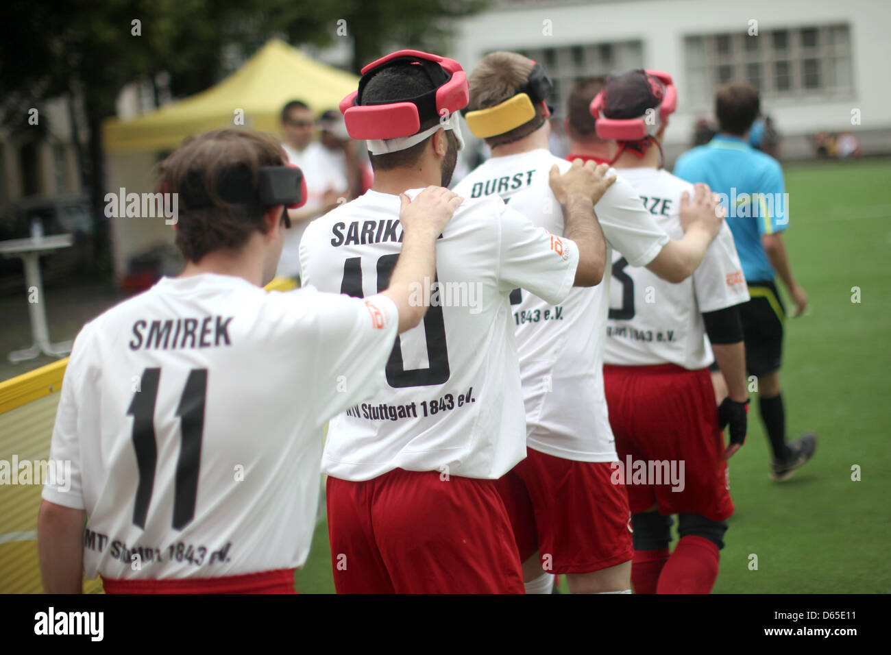 The players of MTV Stuttgart walk onto the pitch for a Blind Bundesliga match at Universitaetsplatz in Heidelberg, Germany, 16 June 2012. In the Blind Bundesliga, the blind players wear protective headgear and chase after a ball with rattles, led by their sense of hearing. Photo: Fredrik von Erichsen Stock Photo
