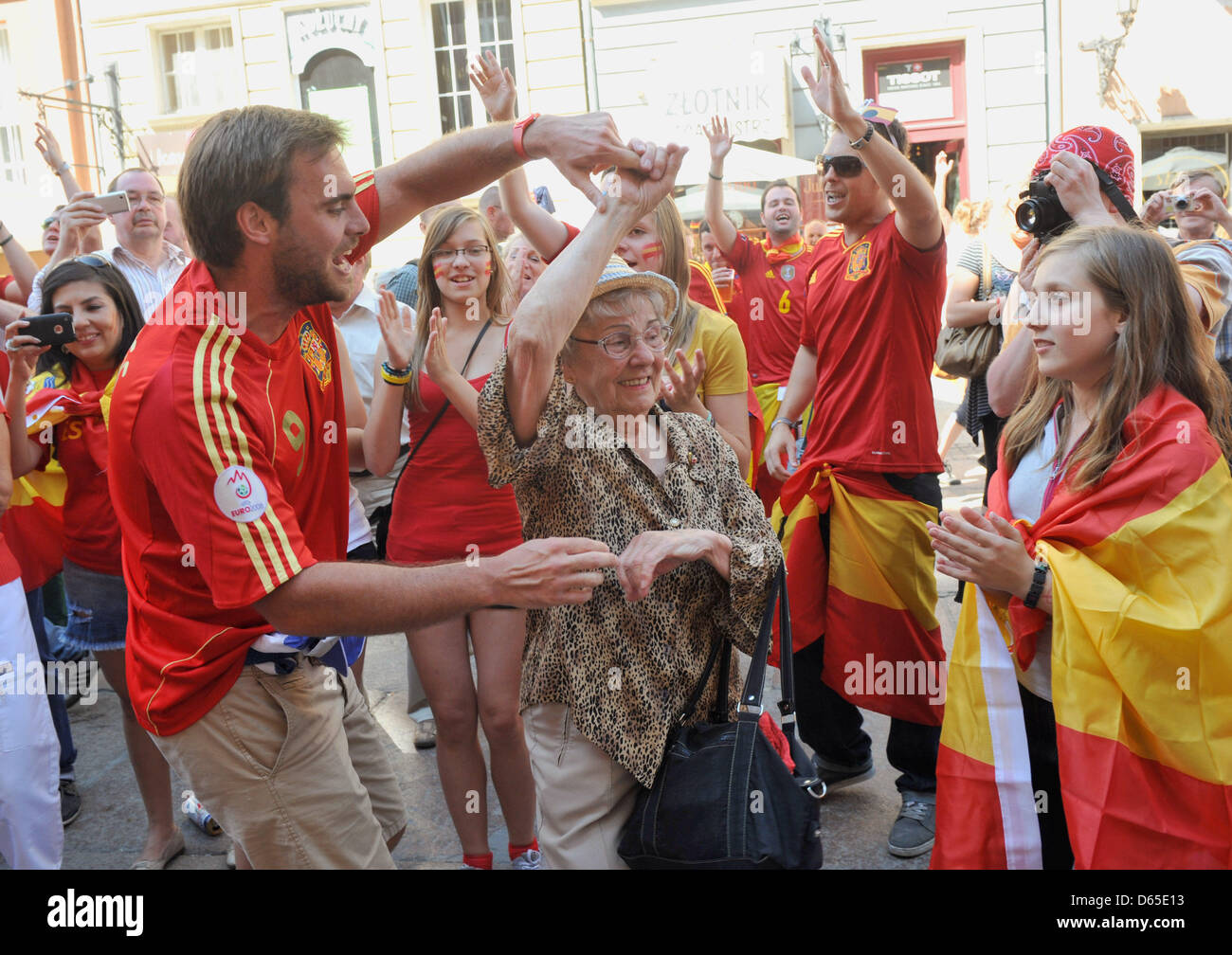 A Spanish Football Supporter Dances With An Elderly Polish Woman Who 