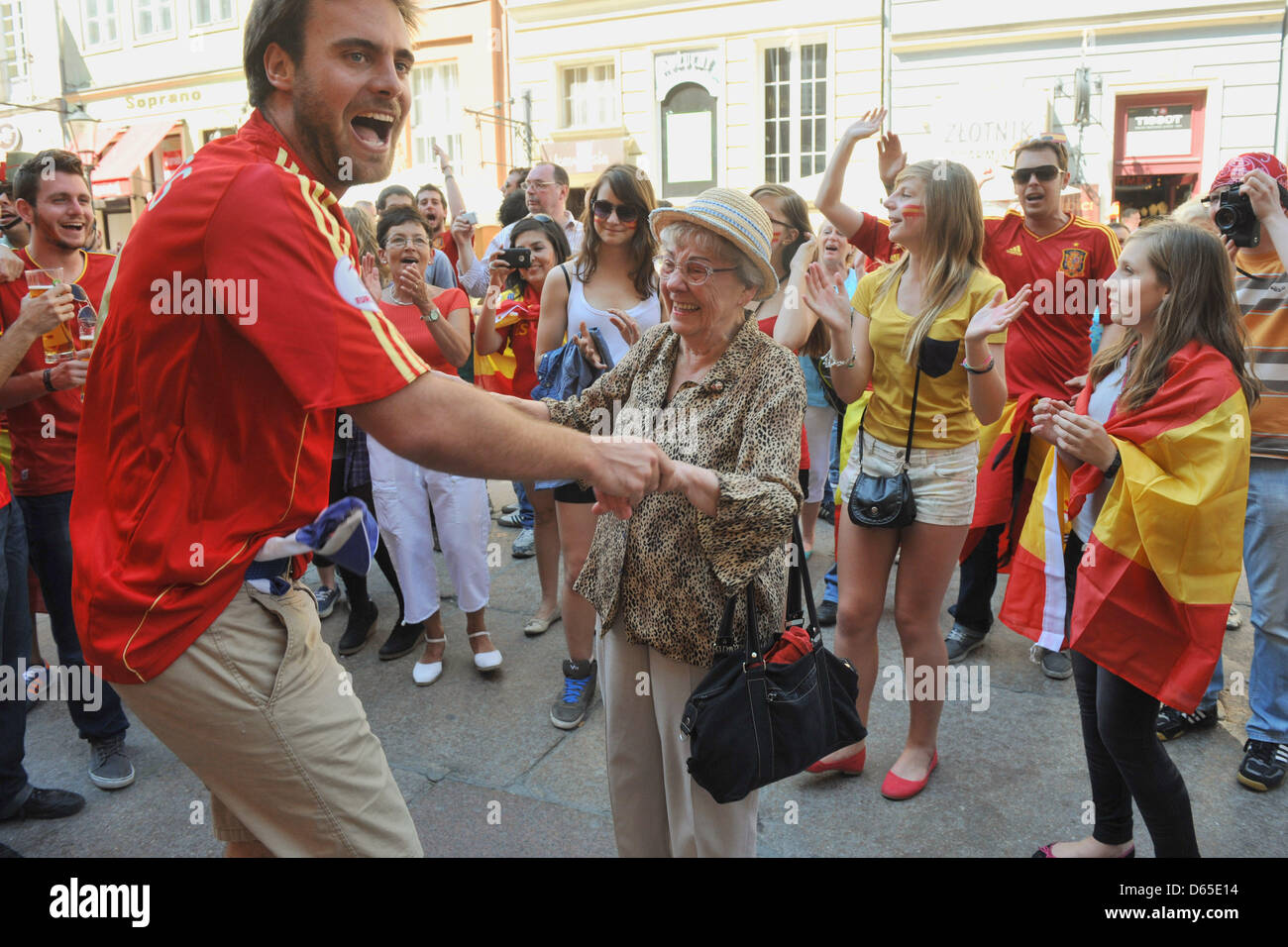 A Spanish Football Supporter Dances With An Elderly Polish Woman Who 