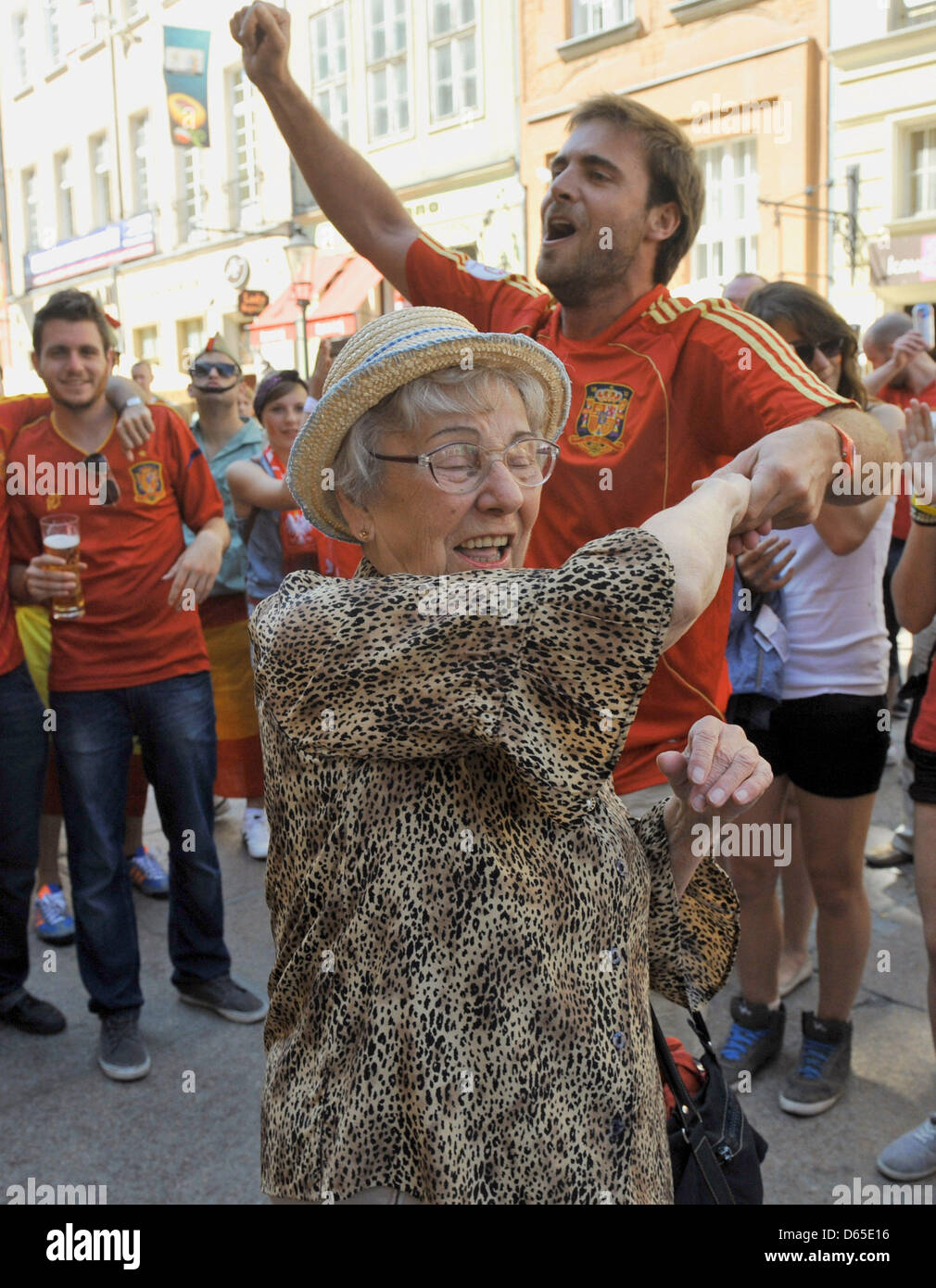 A Spanish Football Supporter Dances With An Elderly Polish Woman Who 