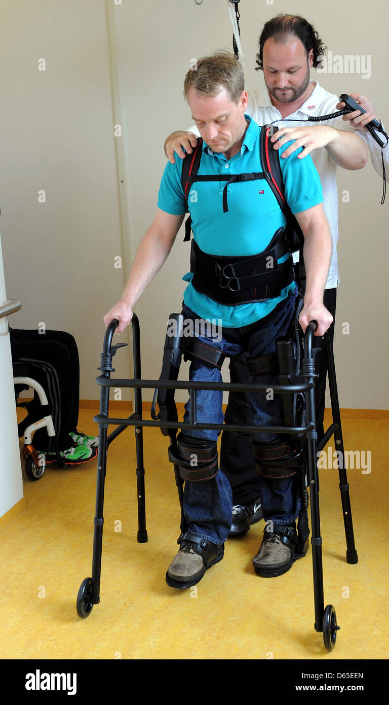 Physiotherapists have affixed walking robot EKSO on the legs of a