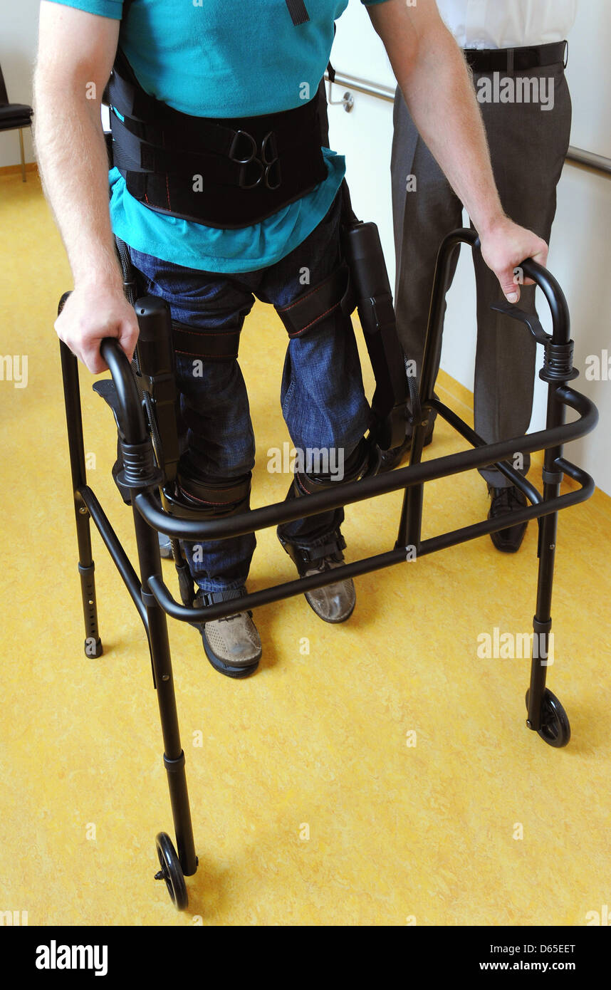 Physiotherapists have affixed walking robot EKSO on the legs of a