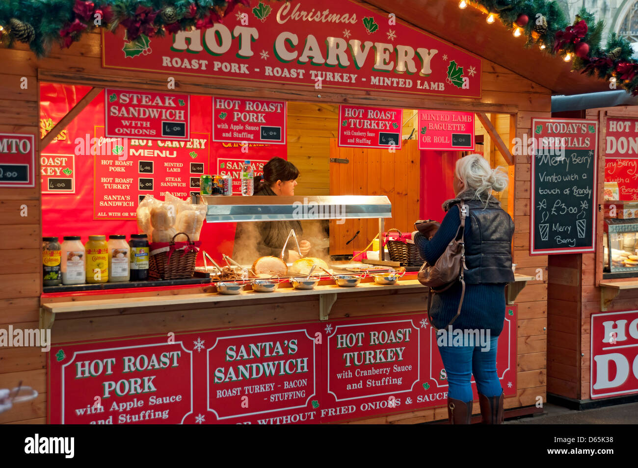 Christmas market stall selling hot meat meats carvery street food in winter York North Yorkshire England UK United Kingdom GB Great Britain Stock Photo