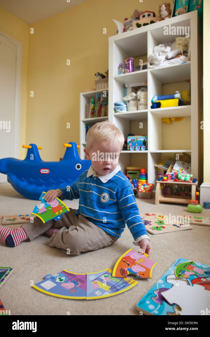 2 Year Old Boy Plays With Various Jigsaw Puzzles In His