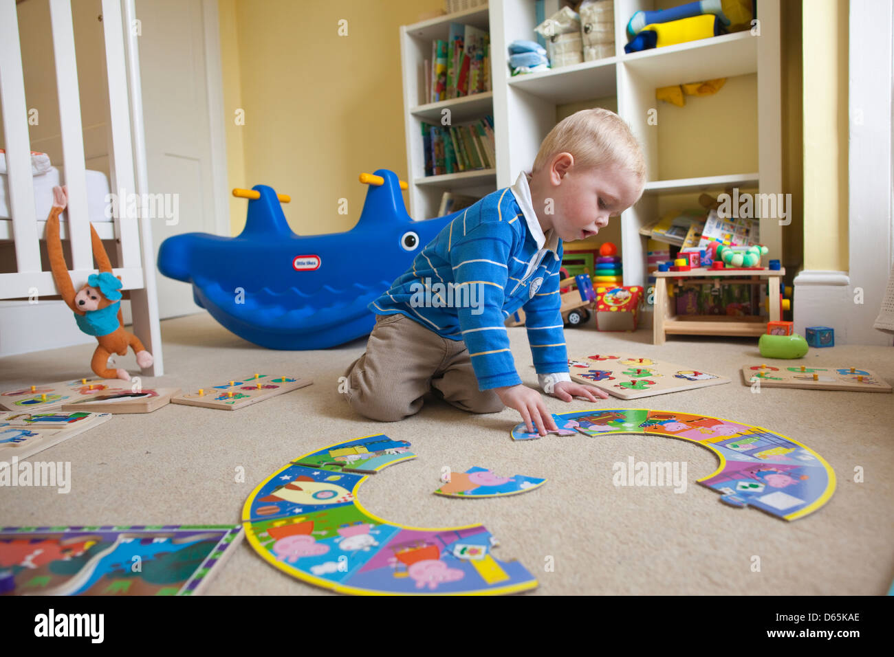 2 Year Old Boy Plays With Various Jigsaw Puzzles In His