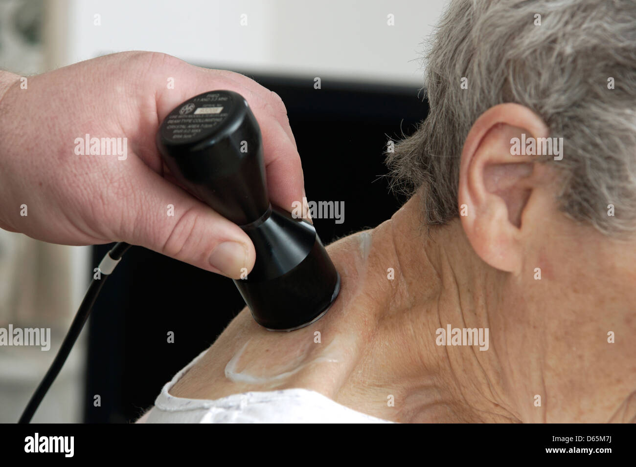 Elderly woman having ultra sound physiotherapy treatment for a painful shoulder Stock Photo