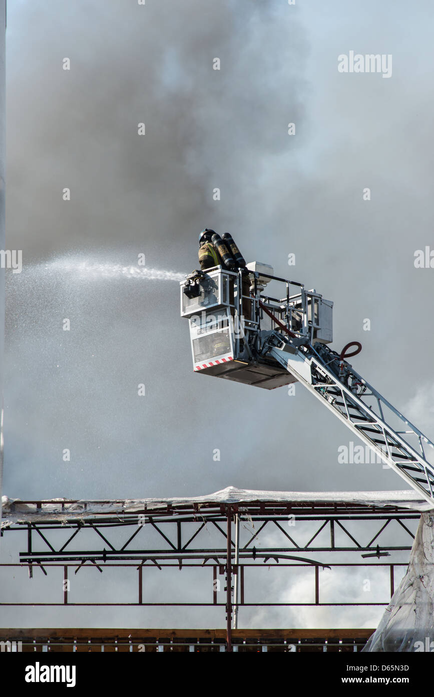 Firemen on a lift Stock Photo