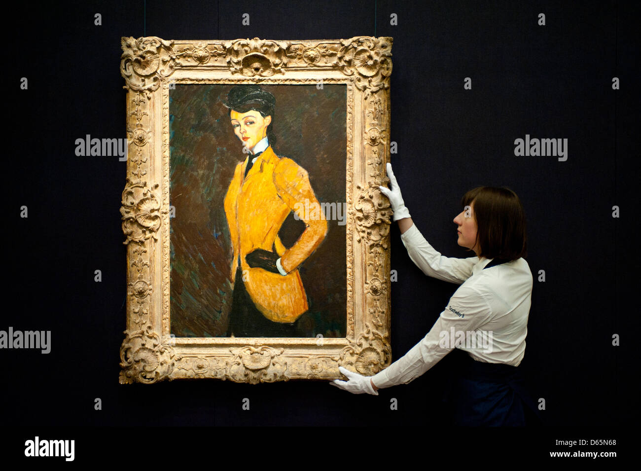 London, UK. 12th April 2013. A Sotheby's employee poses in front of Amedeo Modigliani  'L'Amazone' (Est. $20-30 million). The work will go on sale at Sotheby’s New York in May 2013. The Blockbuster sales at include works by Richter, Modigliani, Picasso, Rodin, Bacon, Cezanne. Credit: Piero Cruciatti / Alamy Live News Stock Photo