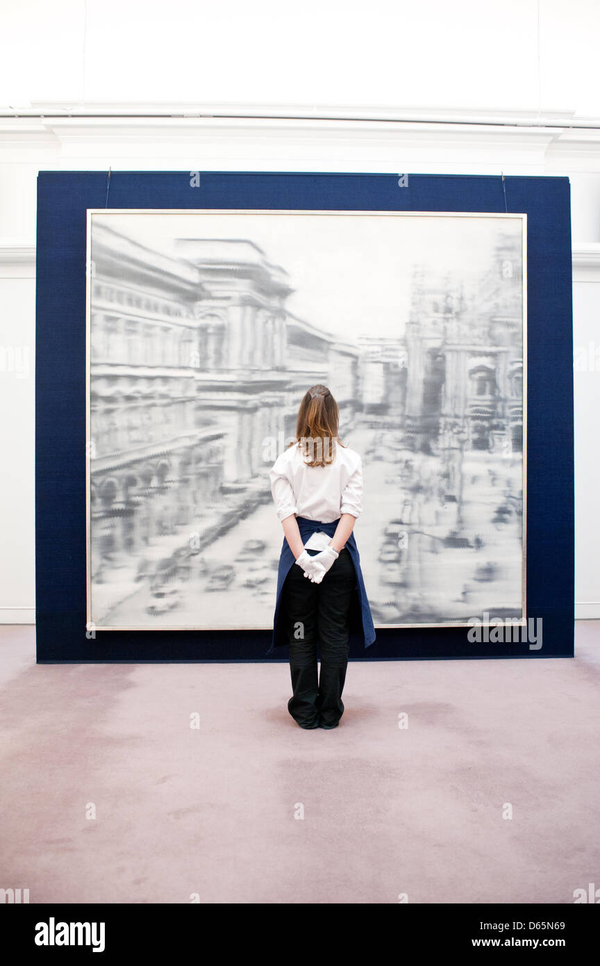 London, UK. 12th April 2013. A Sotheby's employee poses in front of Gerard Richter's photo-realist masterwork (Est. $30-40 million). The work will go on sale at Sotheby’s New York in May 2013. The Blockbuster sales at include works by Richter, Modigliani, Picasso, Rodin, Bacon, Cezanne. Credit: Piero Cruciatti / Alamy Live News Stock Photo