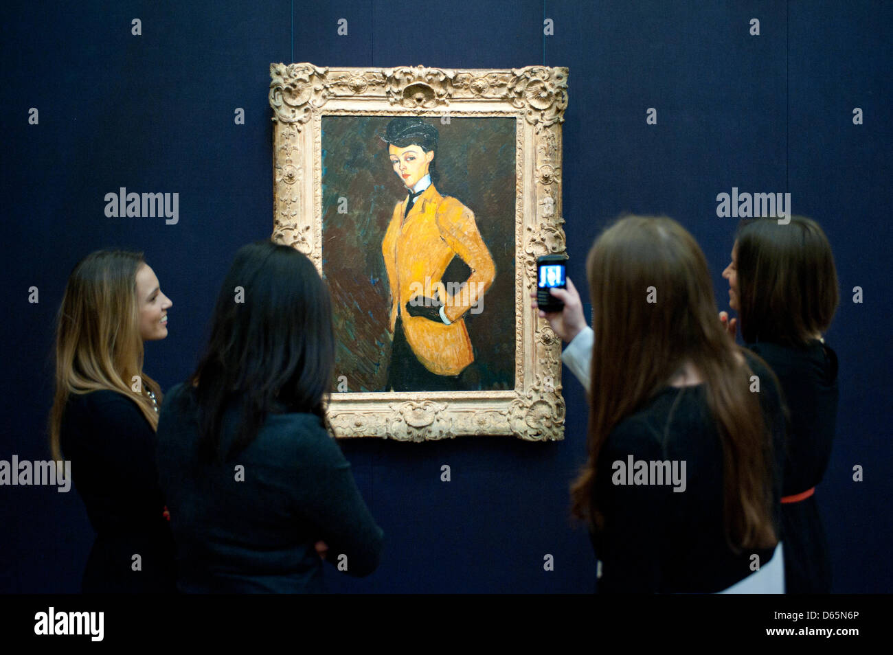 London, UK. 12th April 2013. Sotheby's employees pose in front of Amedeo Modigliani  'L'Amazone' (Est. $20-30 million). The work will go on sale at Sotheby’s New York in May 2013. The Blockbuster sales at include works by Richter, Modigliani, Picasso, Rodin, Bacon, Cezanne. Credit: Piero Cruciatti / Alamy Live News Stock Photo