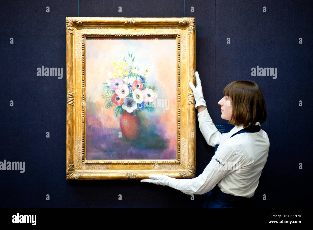 London, UK. 12th April 2013. Sotheby's employee poses in front of Odilon Redon 'Vase d'anemones' (Est. $1,2-1,5 million). The work will go on sale at Sotheby’s New York in May 2013. The Blockbuster sales at include works by Richter, Modigliani, Picasso, Rodin, Bacon, Cezanne. Credit: Piero Cruciatti / Alamy Live News Stock Photo