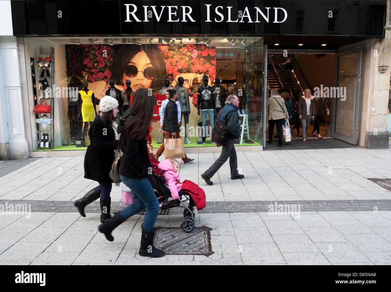 Women shoppers walking past River Island Queen Street Cardiff City Centre Wales UK Stock Photo