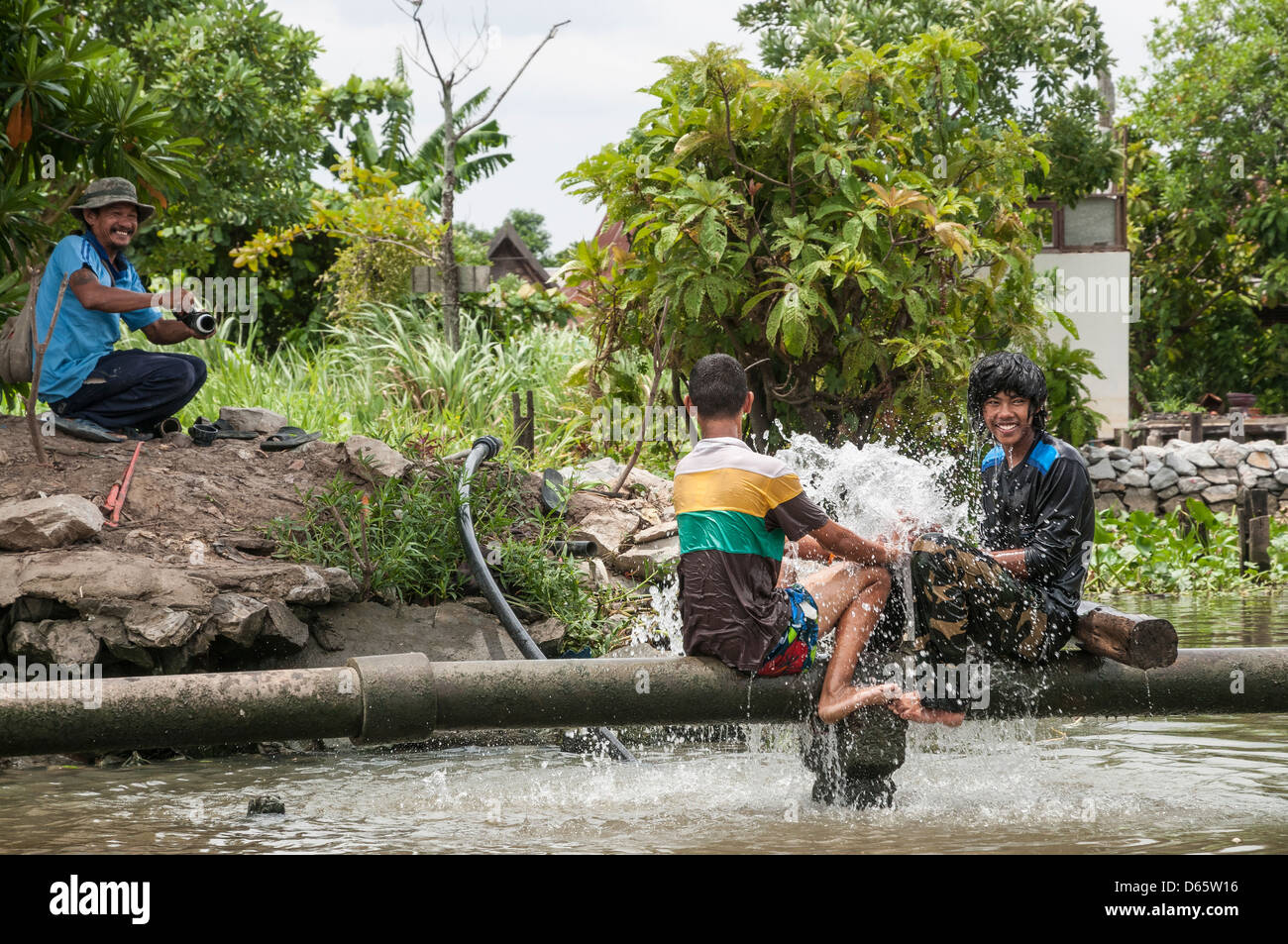 Mending a burst water pipe on the Khlongs in Thonburi, Bangkok
