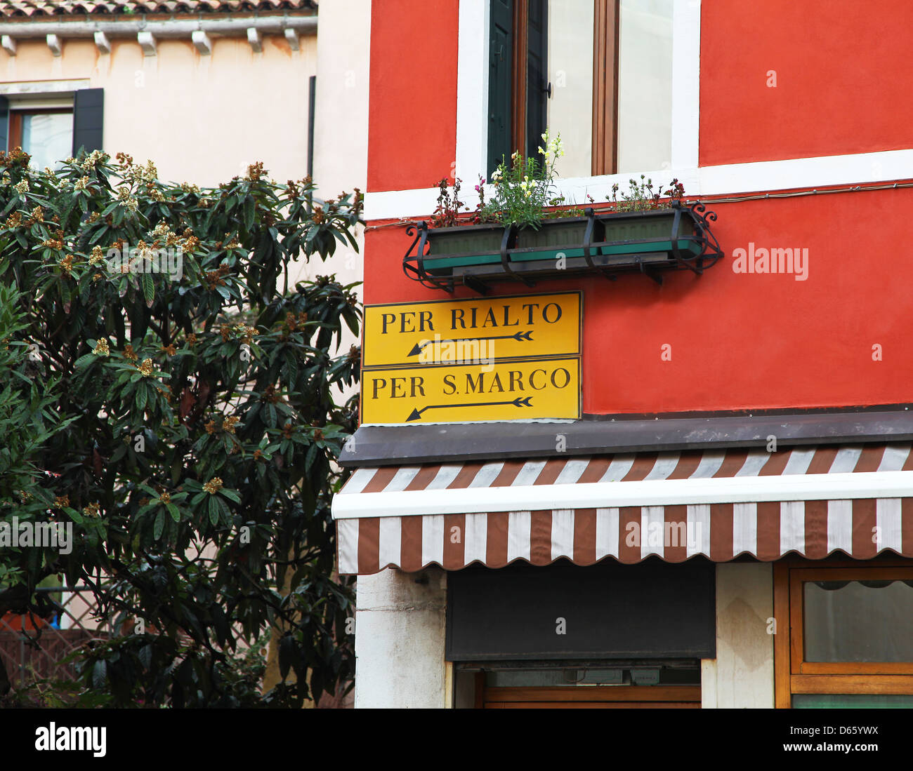 Street signs on a house wall saying Per Rialto and Per S. Marco Venice Italy Stock Photo