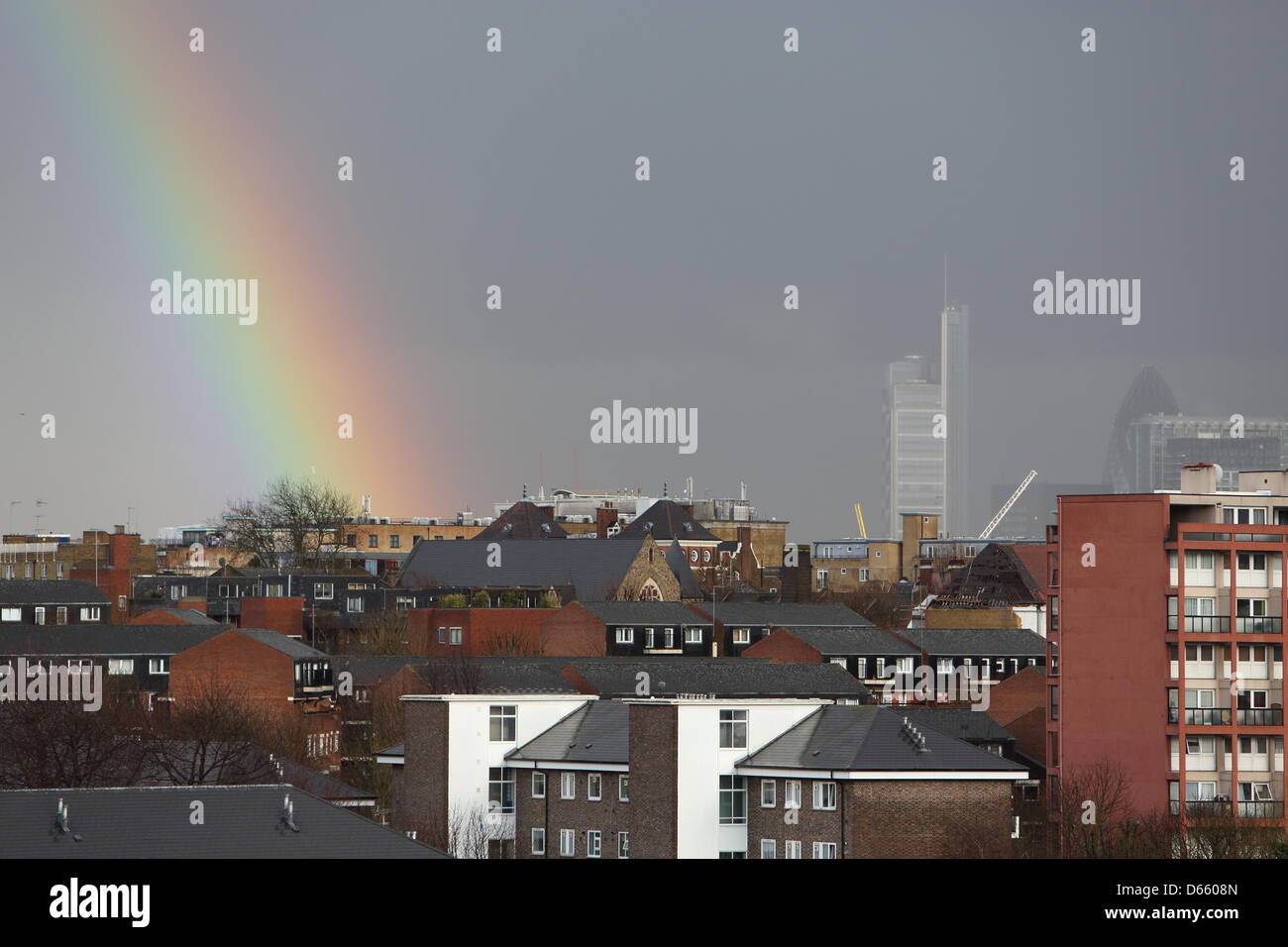 London, UK. Friday 12th April 2013. A rainbow appears during a heavy April shower near the City. Credit: Monica Wells/Alamy Live News Stock Photo