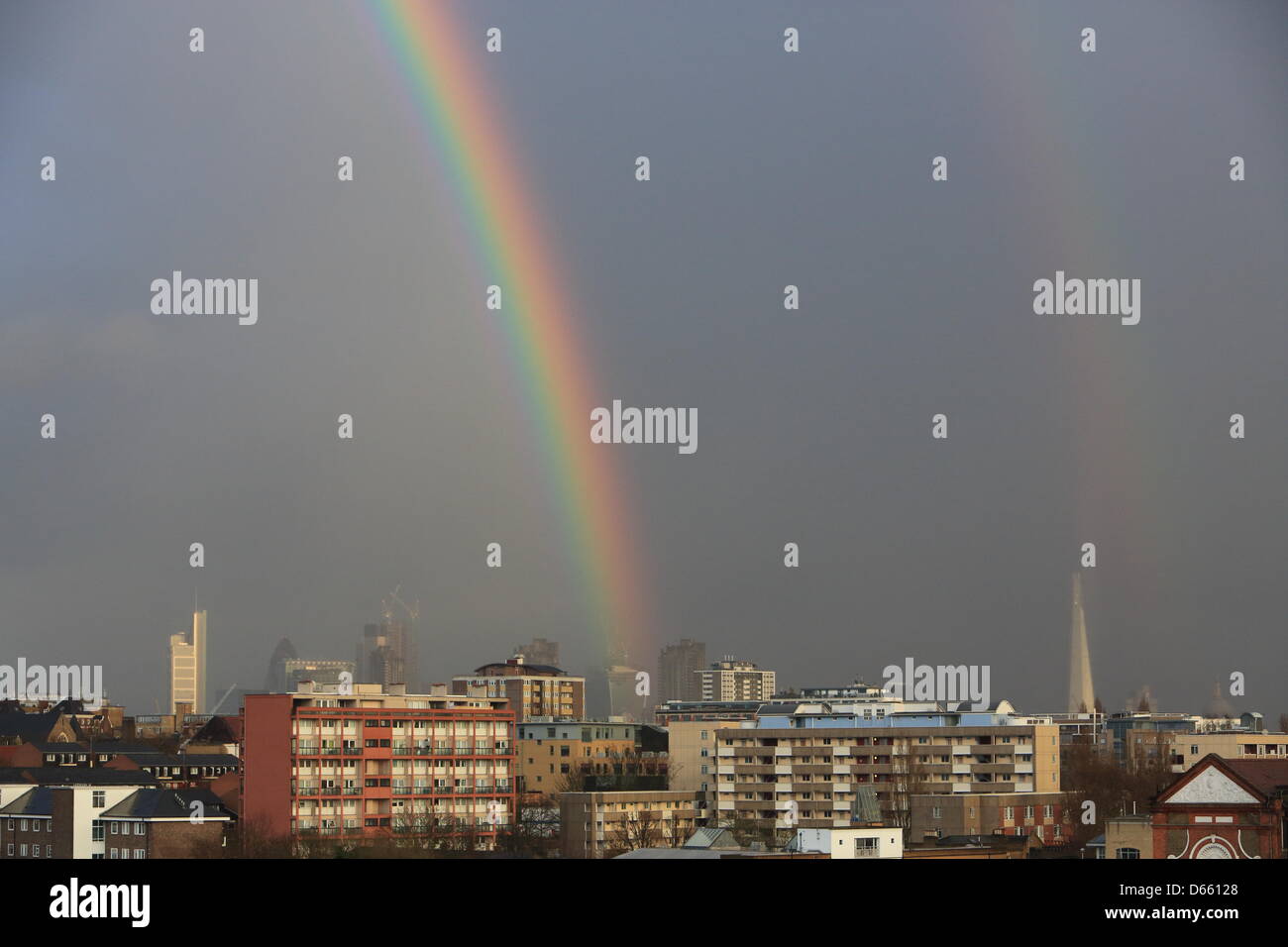 London, UK. Friday 12th, 2013. A double rainbow appears during a heavy April shower over the City in London. Credit: Monica Wells/Alamy Live News Stock Photo