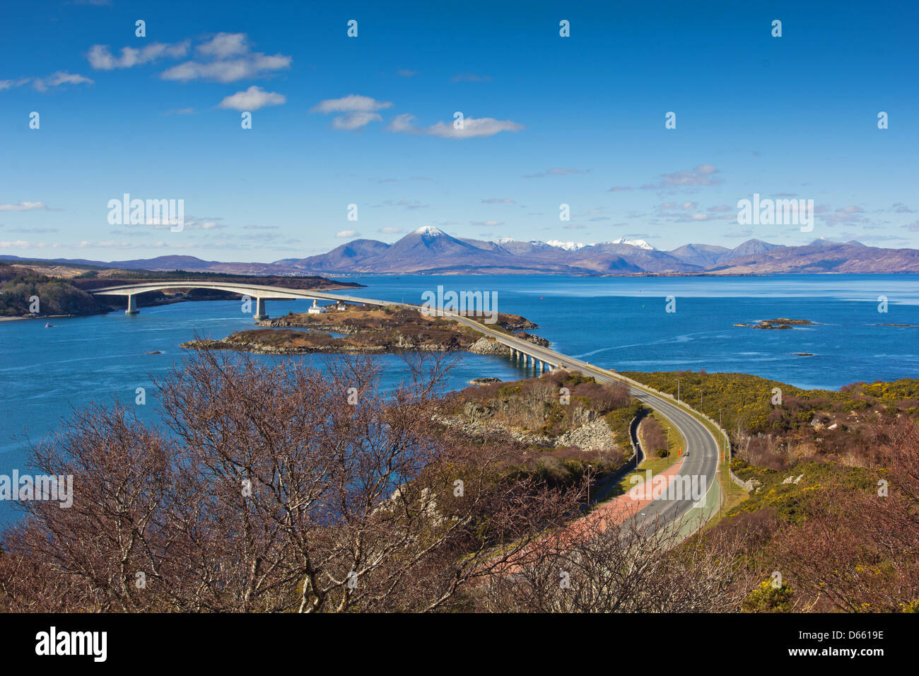 SKYE BRIDGE AND LOCH ALSH WITH THE SNOW CAPPED CUILLIN MOUNTAINS  ON AN EARLY SPRING DAY, WEST COAST SCOTTISH HIGHLANDS Stock Photo