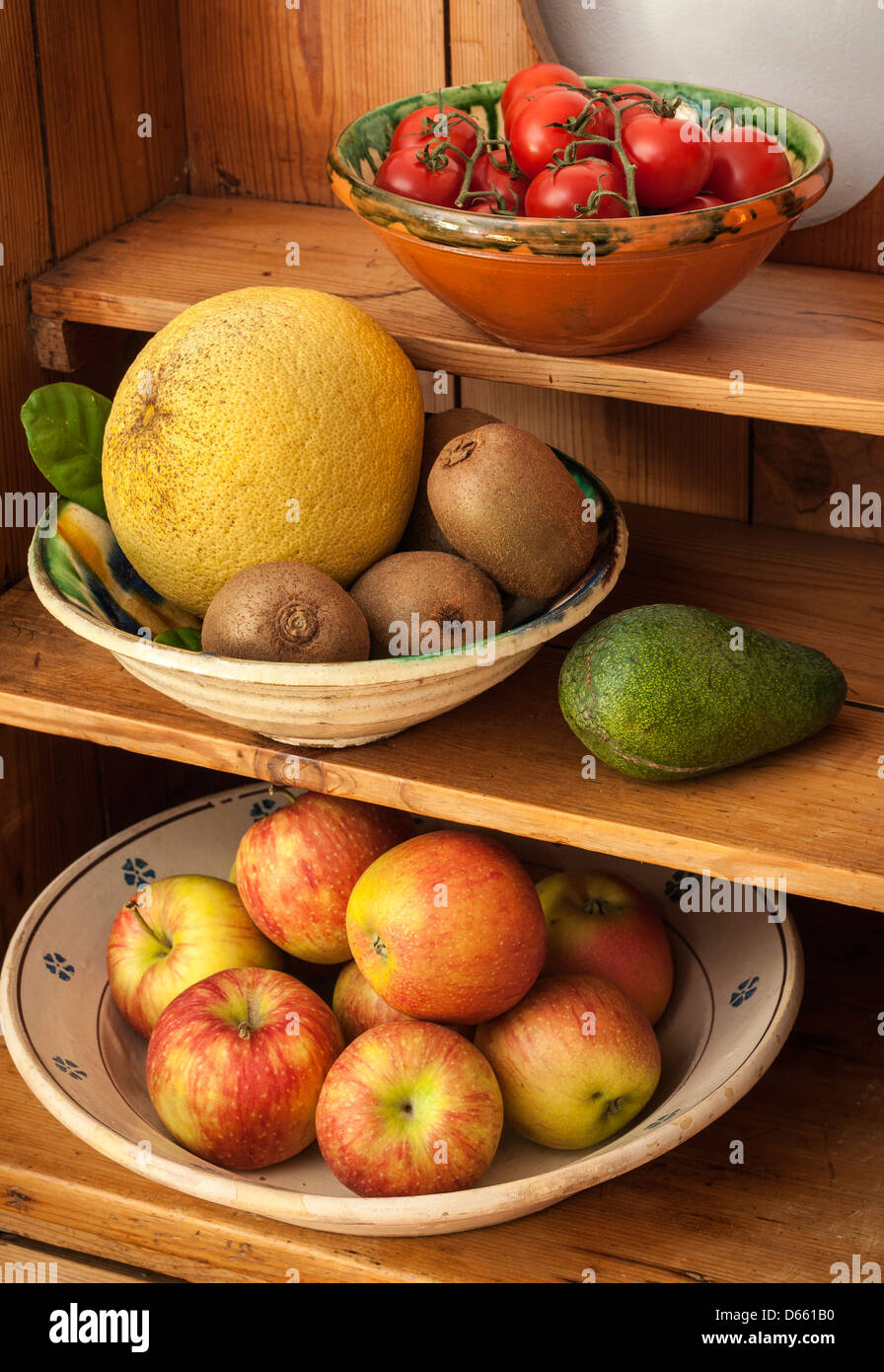 Assorted fruit and vegetables on a kitchen dresser Stock Photo