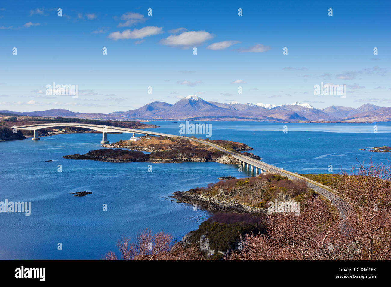 SKYE BRIDGE CROSSING THE KYLE OF LOCH ALSH ON AN EARLY SPRING DAY WITH THE SNOW CAPPED CUILLINS IN THE BACKGROUND Stock Photo