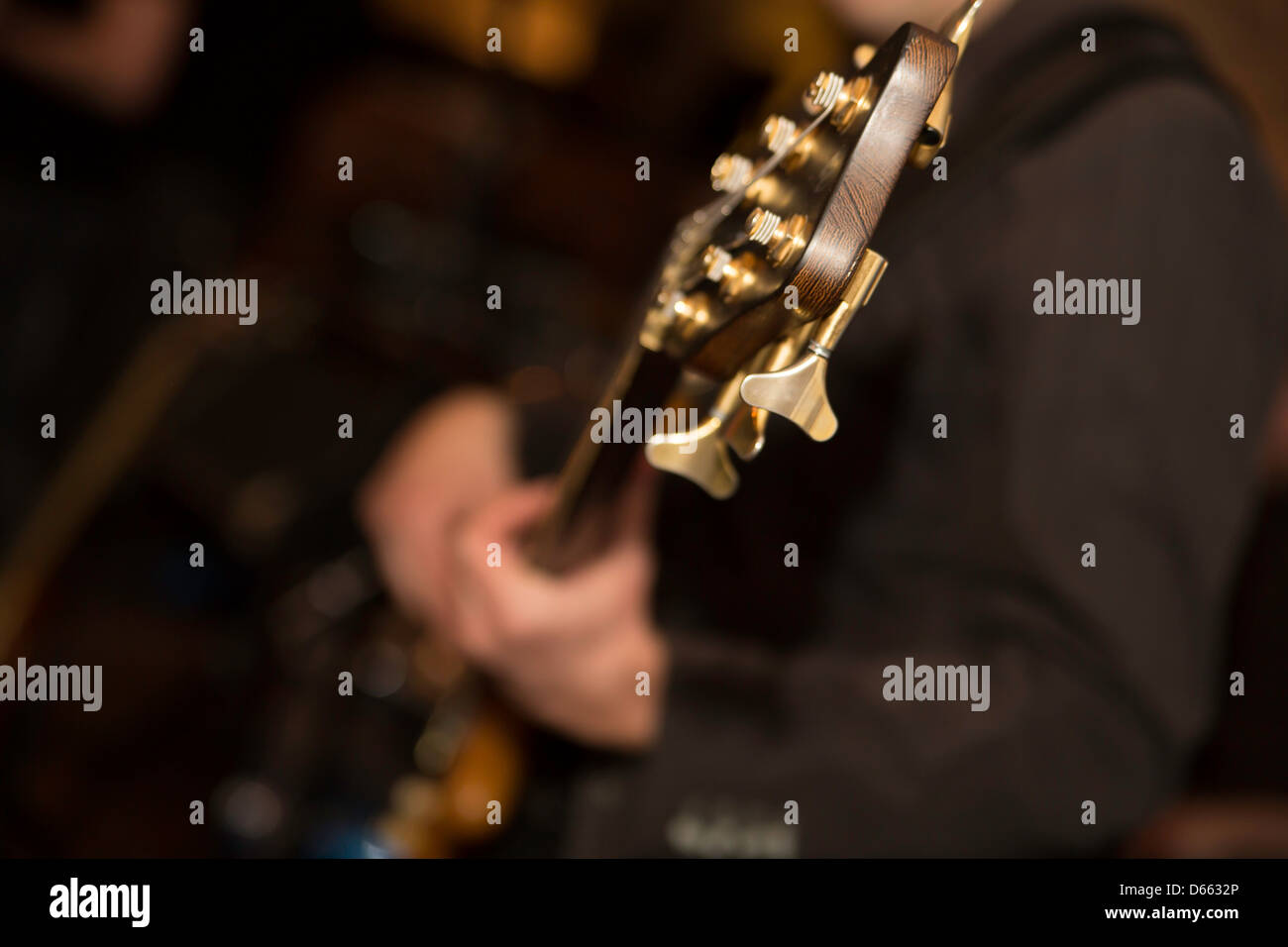 Zoomed guitar neck head with six energized strings Stock Photo