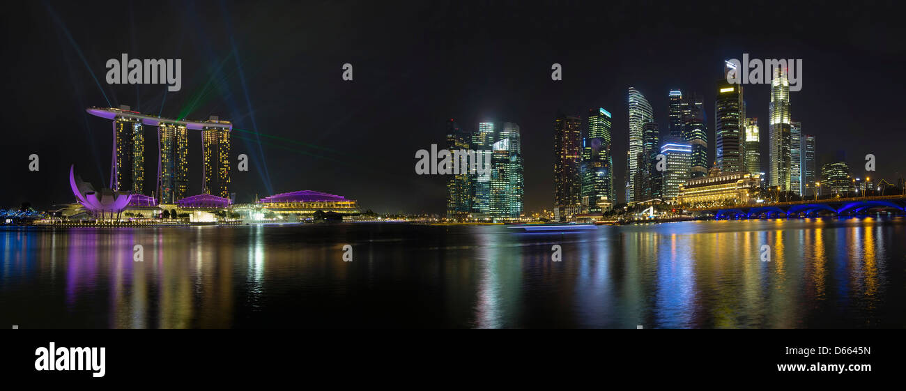 Singapore City Skyline with Laser Light Show Along Singapore River at Night Panorama Stock Photo
