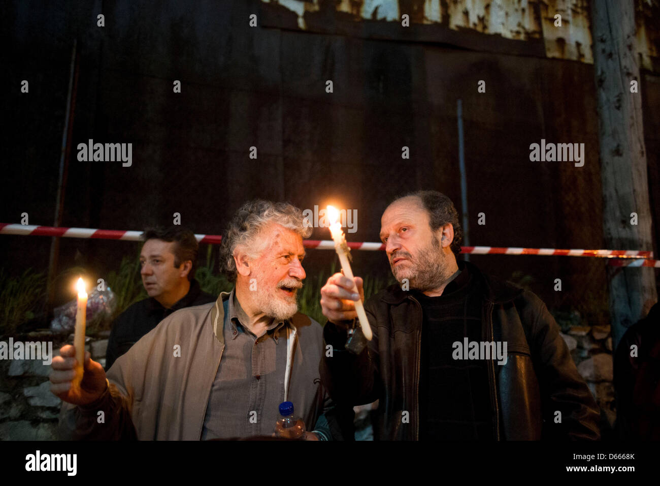 Residents of Ierissos village, Greece's northern Halkidiki peninsula, with candles shout slogans during a rally outside police headquarters in the northern Greek port city of Thessaloniki late Friday, April 12, 2013 Stock Photo