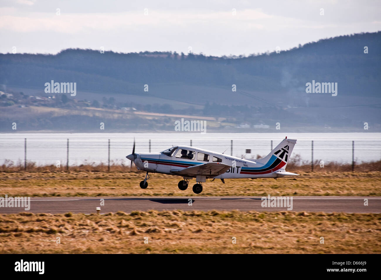 Tayside Aviation Piper PA-28 Warrior G-BIIT aircraft taking off from the runway at Dundee Airport,UK Stock Photo