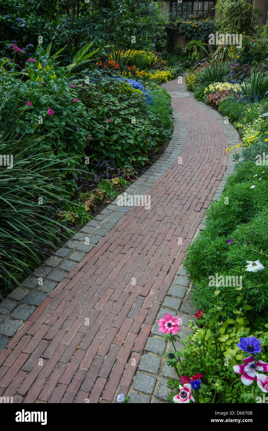 Brick Path Through Flower Garden Stock Photo