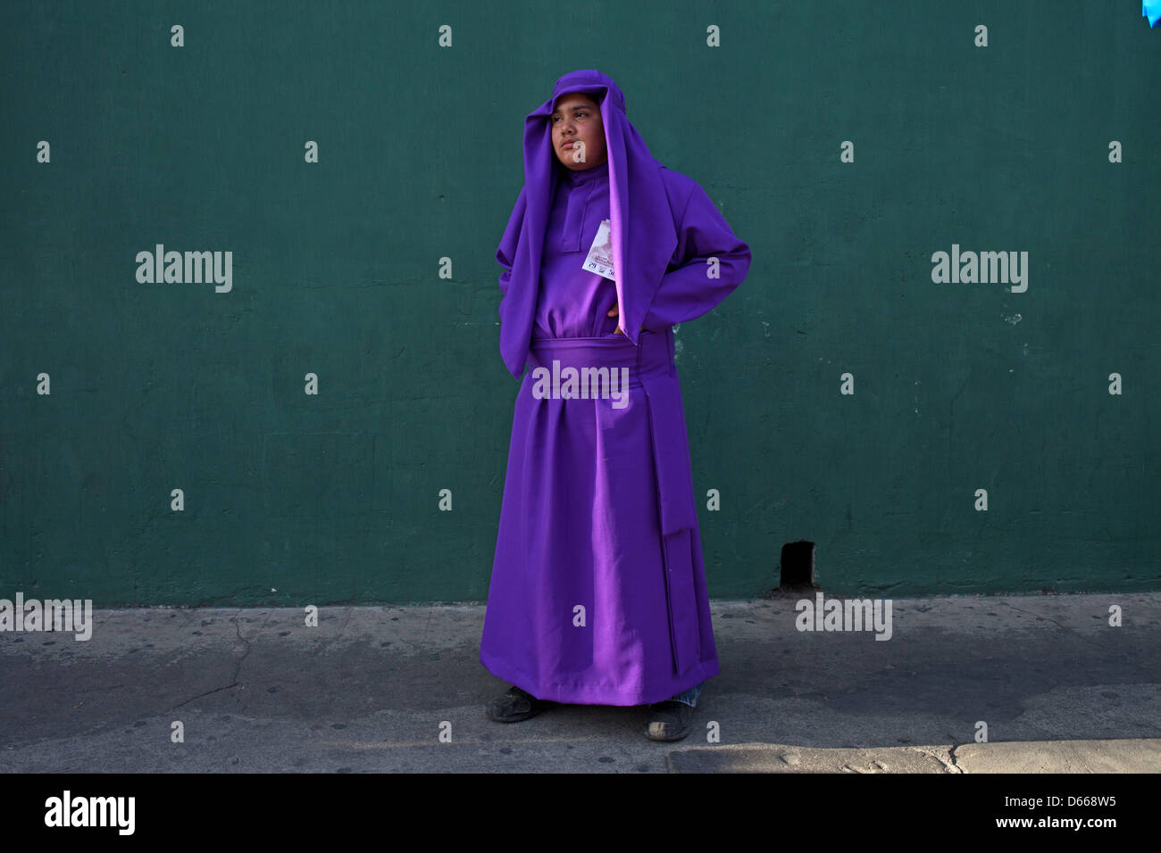 Young penitent dressed in purple clothes during Easter Holy Week in Antigua Guatemala Stock Photo