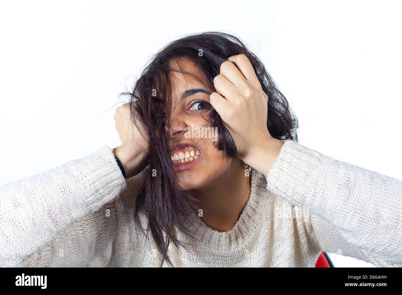 Hysterical woman expression with her hands on the head on a white isolated background Stock Photo