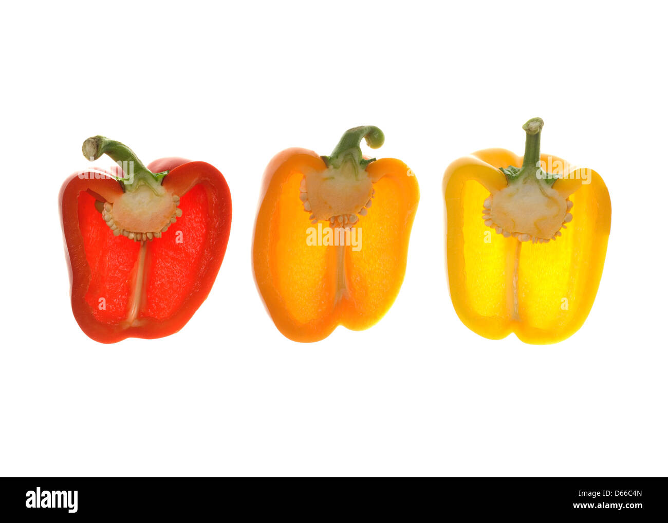 Three mixed bell peppers in a row cut open, back lit Stock Photo