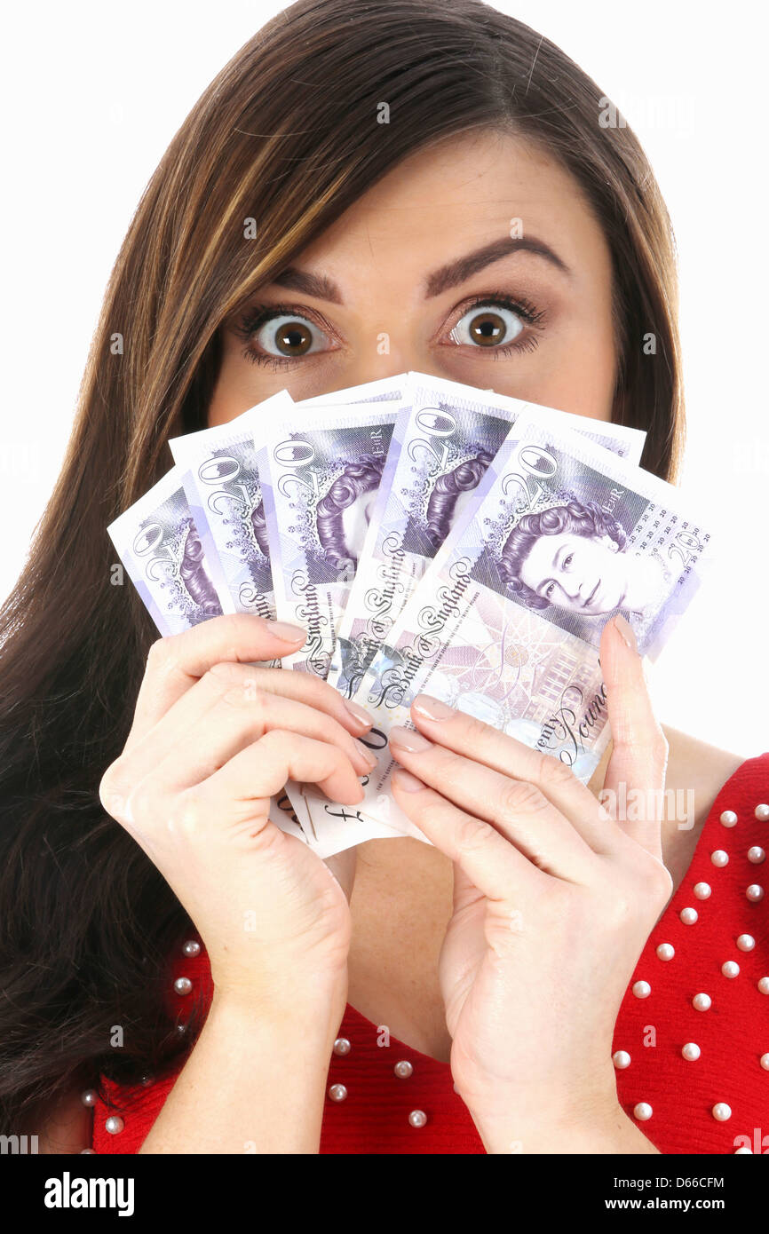 Confident Happy Young Woman, Wearing Red Dress, Holding Money Or Cash Celebrating Winning, Isolated Against A White Background With Clipping Path Stock Photo