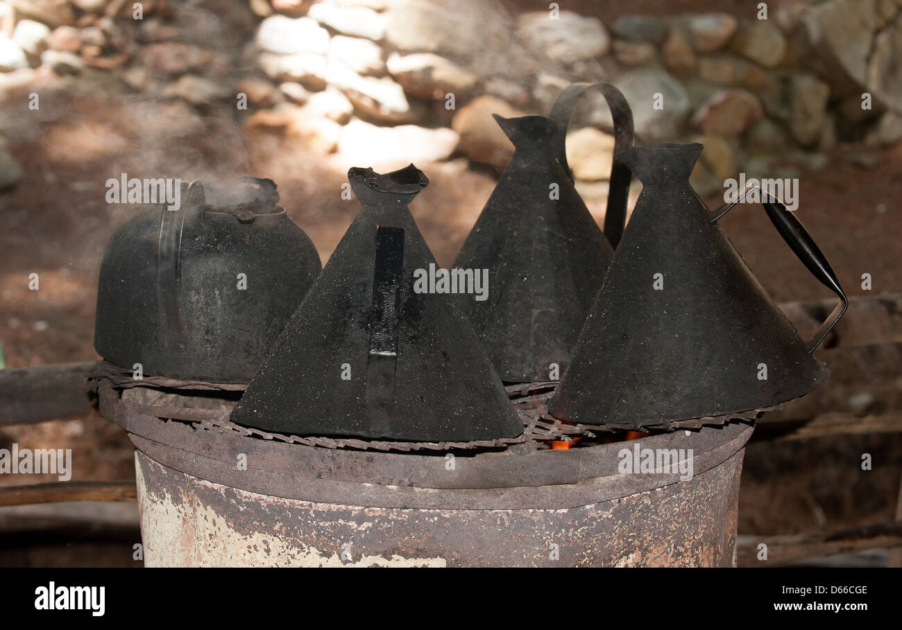 Black kettles for boiling water on an open fire Stock Photo Alamy