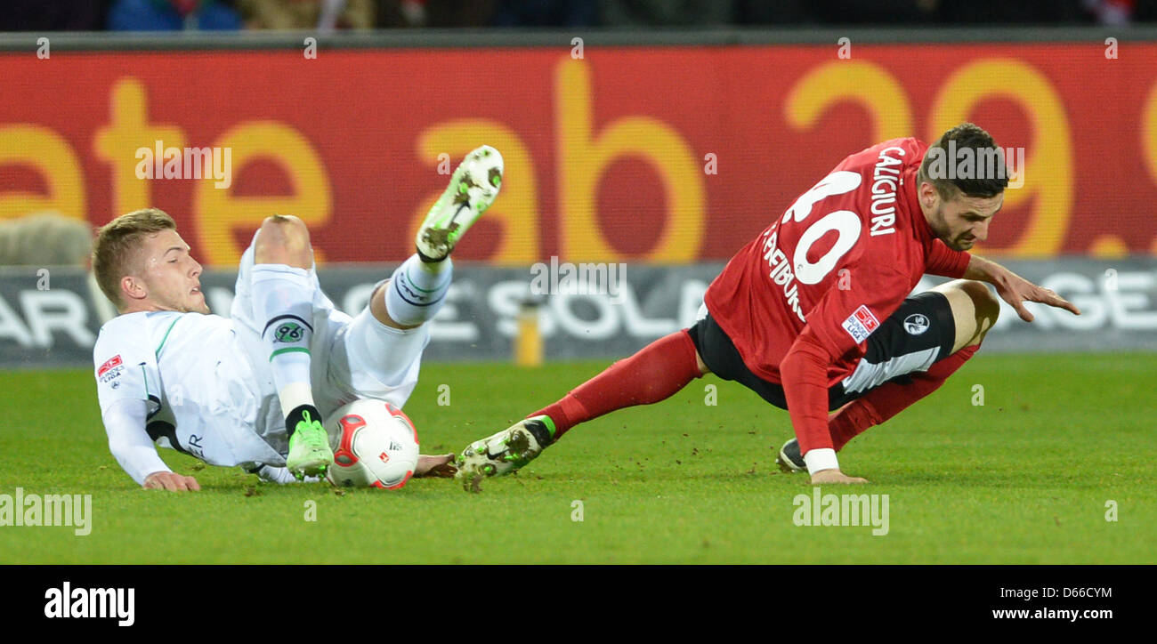 Hanover's Andre Hoffmann vies for the ball with Freiburg's Daniel Caligiuri (R) during the German Bundesliga soccer match between SC Freiburg and Hannover 96 at Mage Solar Stadium in Freiburg, Germany, 12 April 2013. Photo: Patrick Seeger Stock Photo