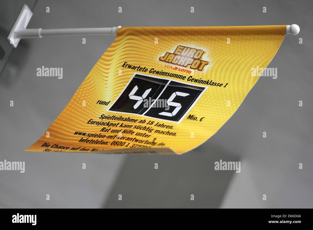 A flag displays the expected Euro Jackpot winning amount of 45 million  euros at a lottery business in Wiesbaden, Germany, 13 April 2013. The  winning numbers were drawn in Helsinki on 12
