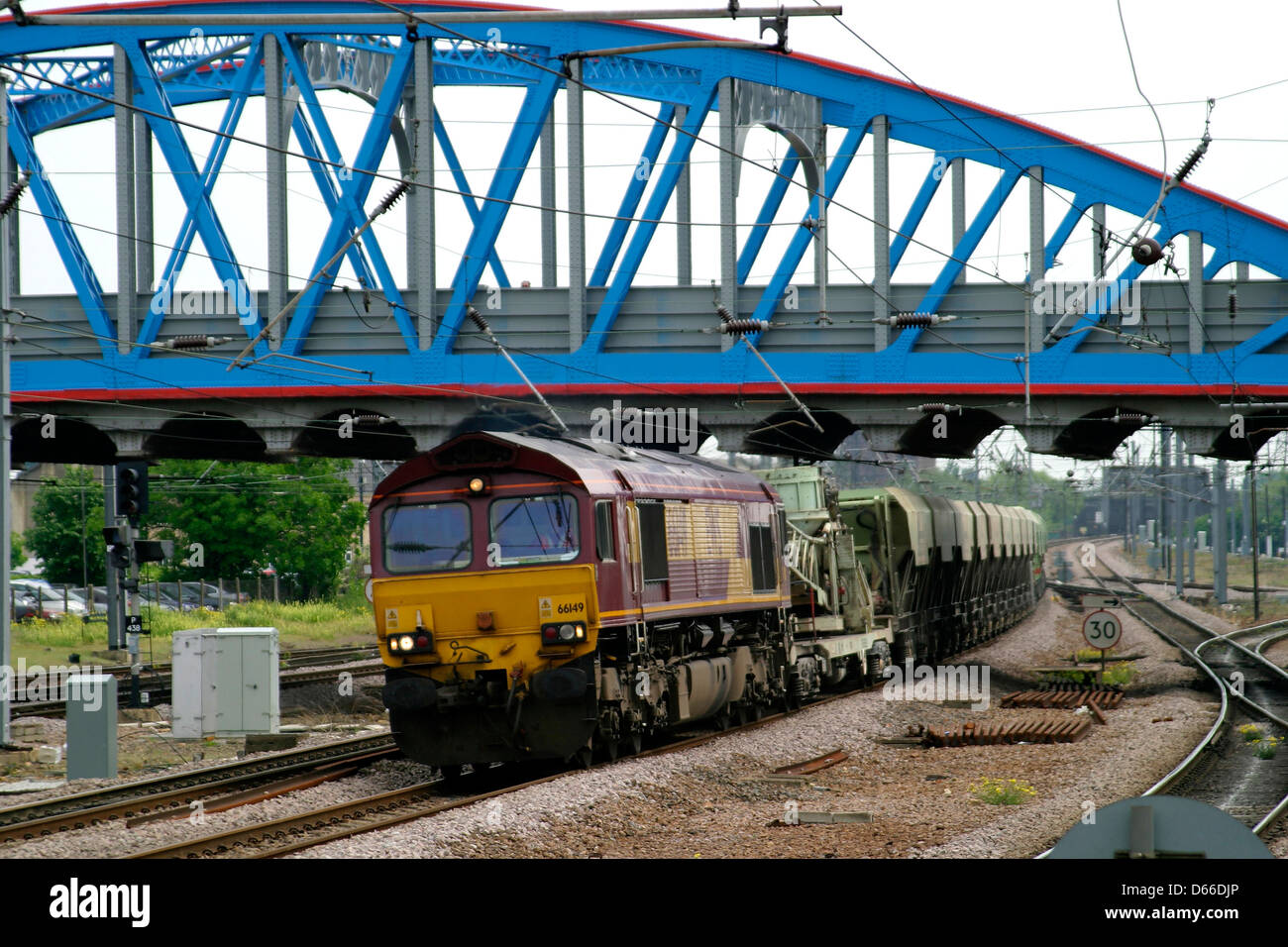 EWS 66149 line of Lafarge hoppers passing through, Peterborough Station