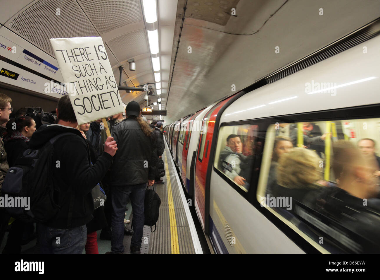 London, UK. 13th April 2013.  Protesters boarding an underground train on the way to Lord Freud's London home. Lord Freud is Welfare Minister and a key proponent of the 'bedroom tax'.Credit: Rob Pinney/Alamy Live News Stock Photo