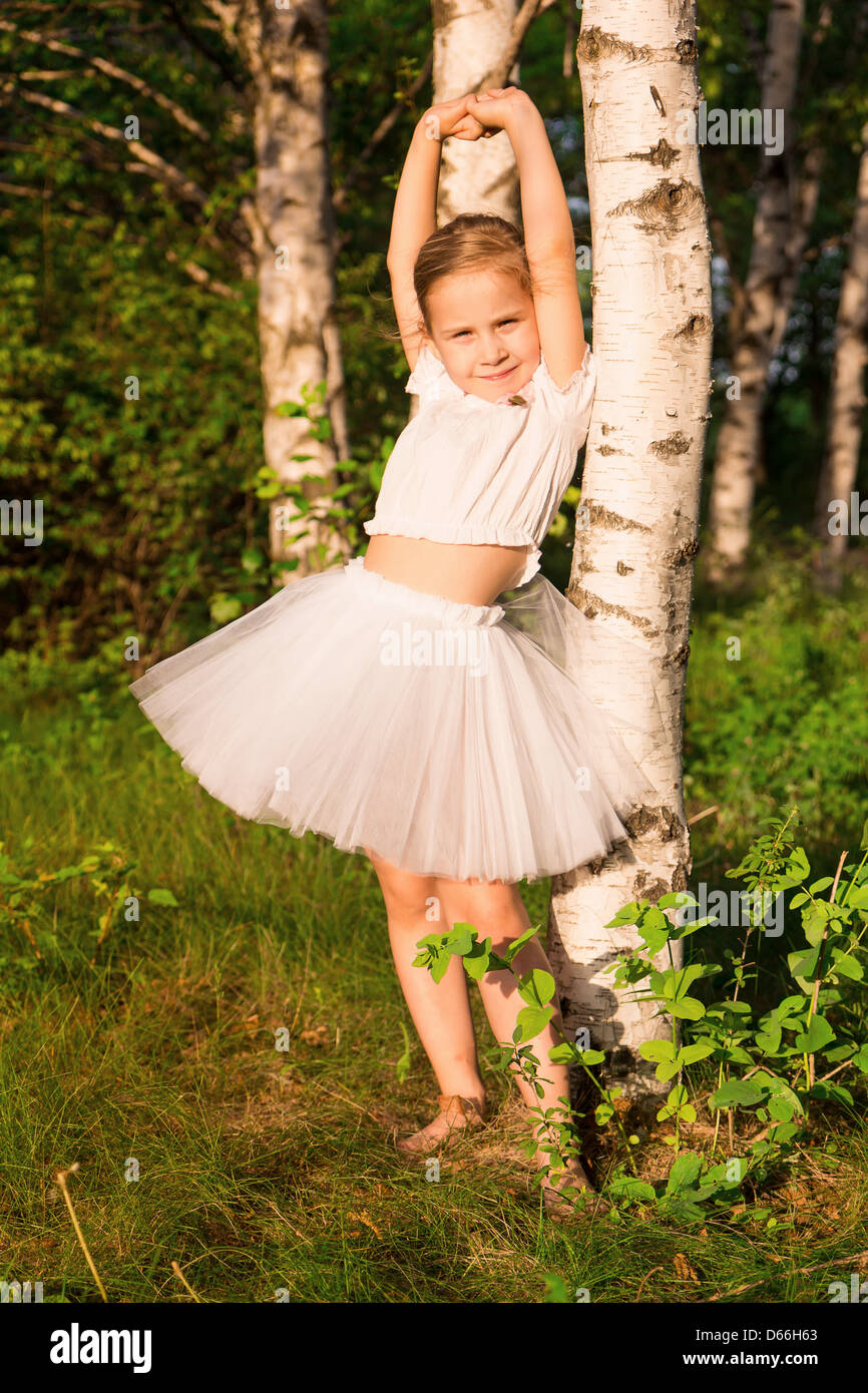 Beautiful little girl in the forest near birch outdoor Stock Photo - Alamy
