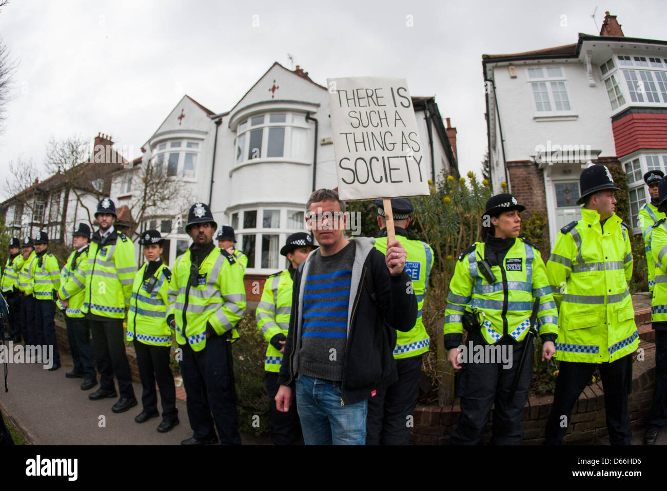 London, UK. 13th April 2013. Police line the street as UK Uncut stage 'Who Wants to Evict a Millionaire' event outside the home of Lord Freud, architect of the Welfare Reform Bill. Credit: Martyn Wheatley / Alamy Live News Stock Photo