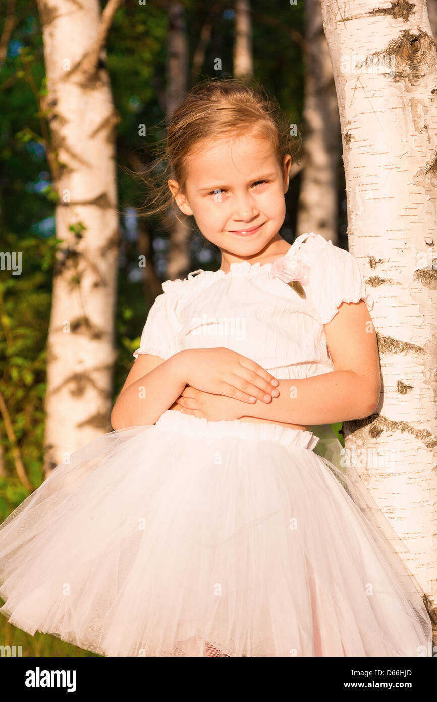 Beautiful little girl in the forest near birch outdoor Stock Photo - Alamy