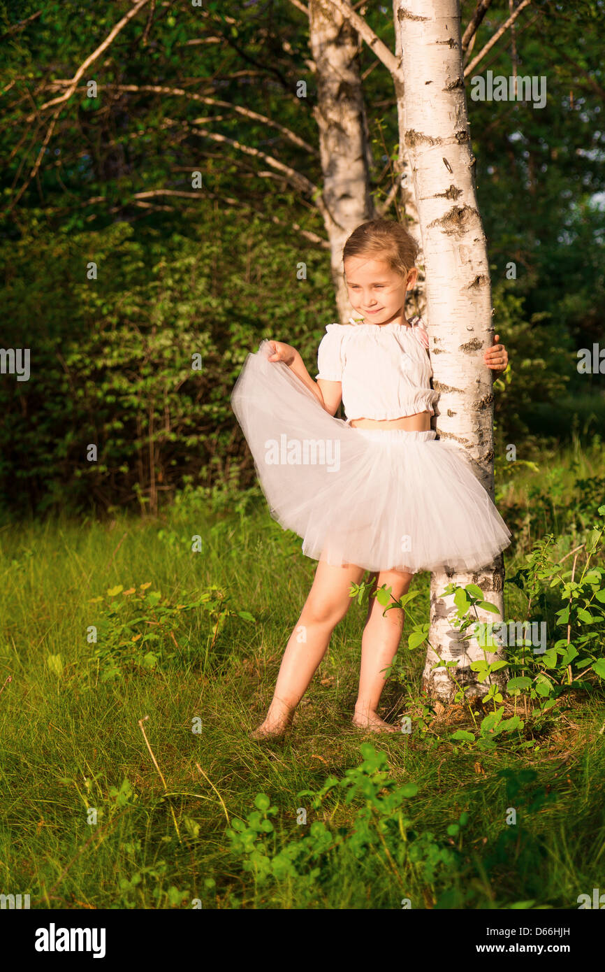 Beautiful little girl in the forest near birch outdoor Stock Photo - Alamy