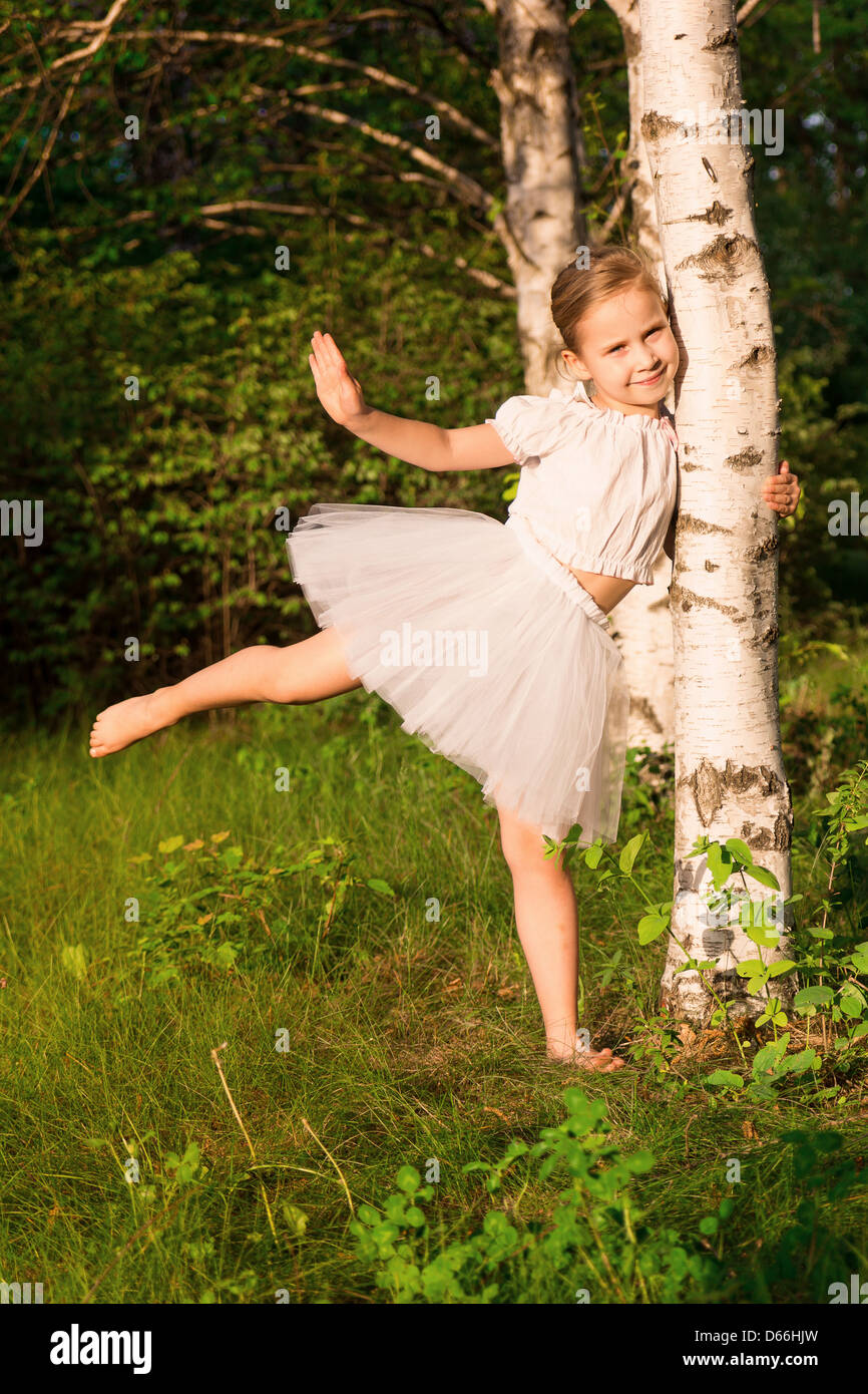 Beautiful little girl in the forest near birch outdoor Stock Photo - Alamy