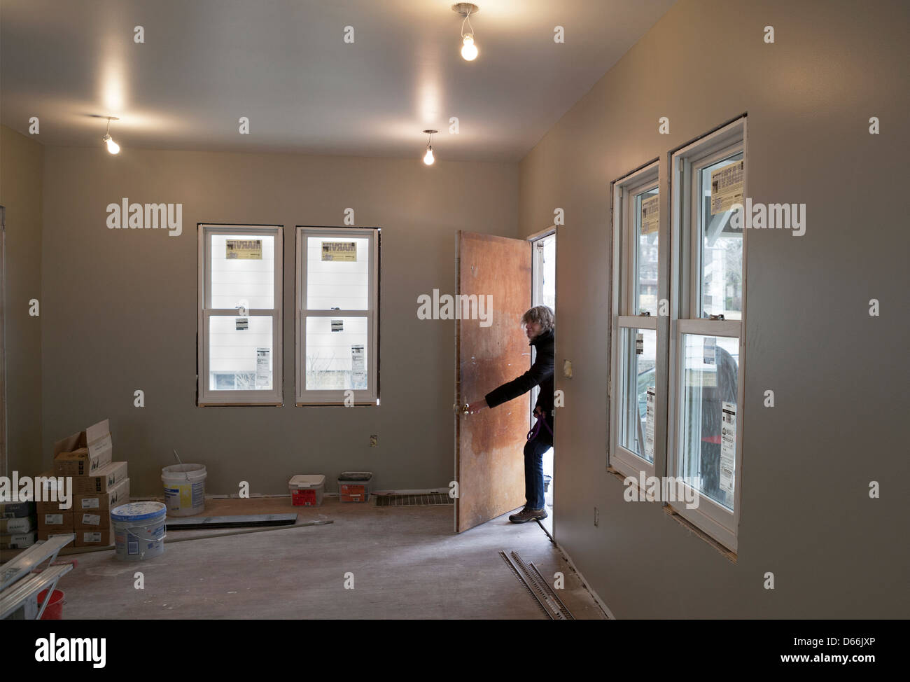 The new owner of a foreclosed house comes to inspect the construction work that has been done. Stock Photo