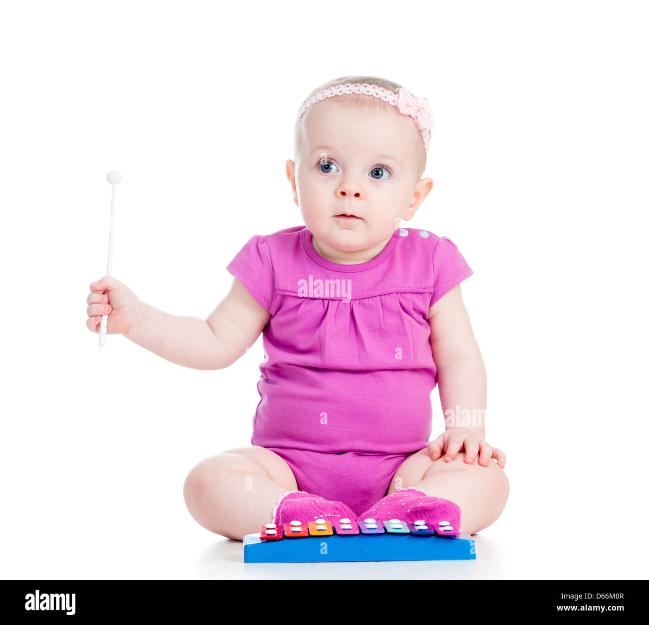 girl baby playing musical toy Stock Photo