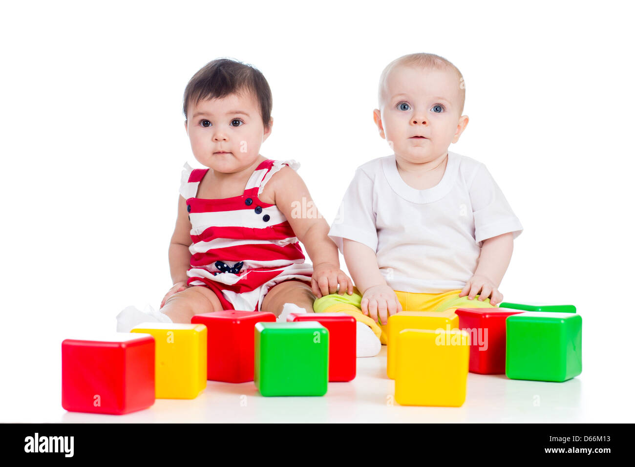 two babies or kids playing together with color toys Stock Photo