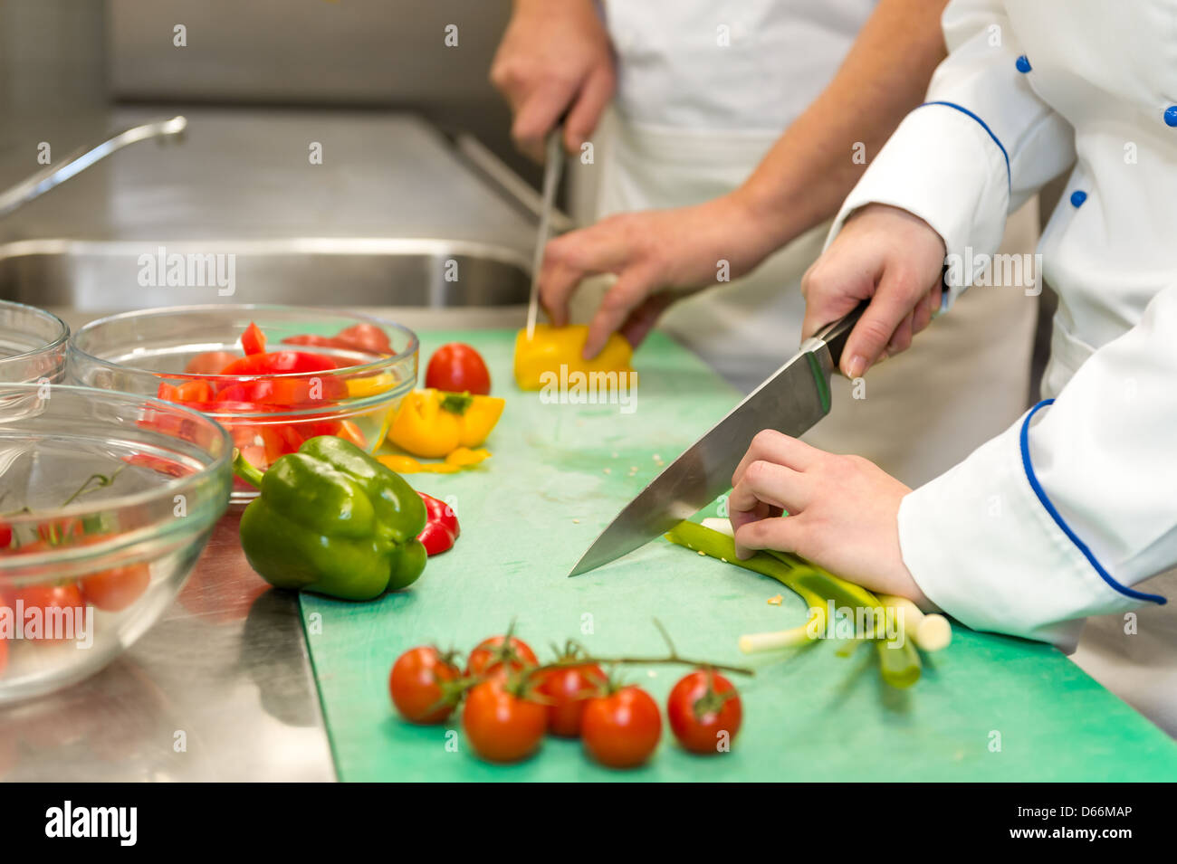 https://c8.alamy.com/comp/D66MAP/close-up-of-chefs-cutting-vegetables-in-hotels-kitchen-D66MAP.jpg