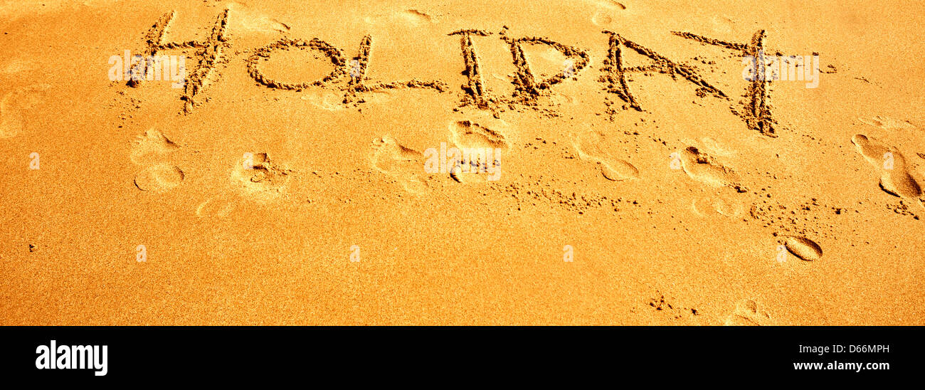 Messages and words written in the sand on a beach. Topical for travel agents and holidays Stock Photo